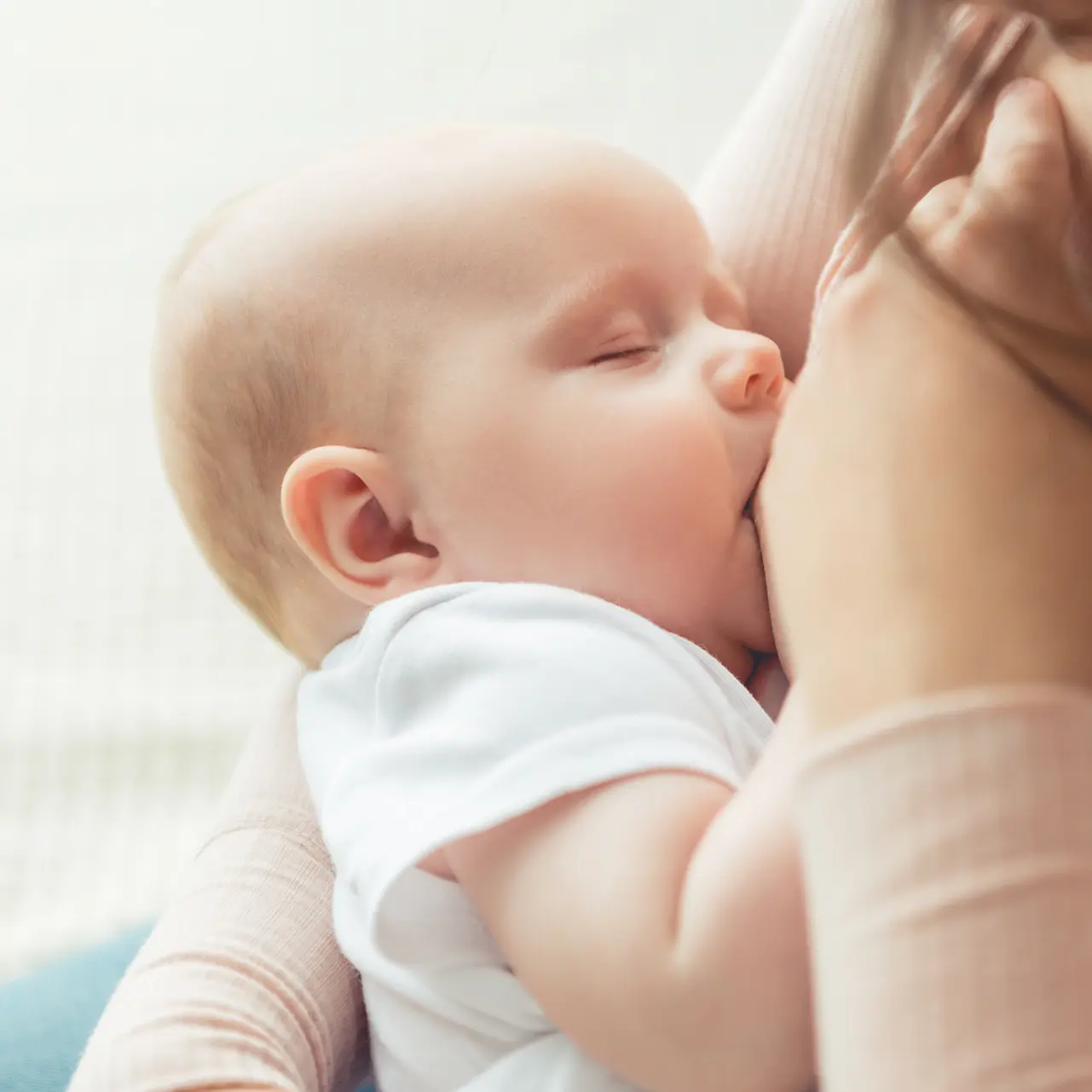 baby sucking milk from mother